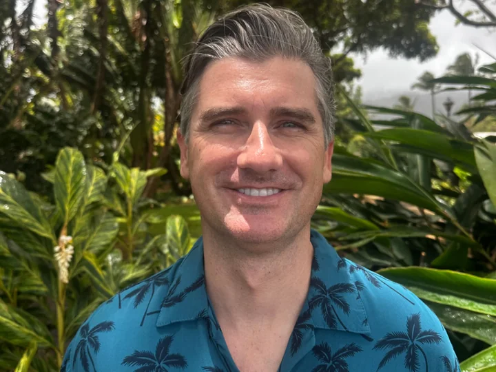 HawaiiWebSEO team member in a palm-print shirt standing in tropical foliage